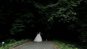 Bride and groom walking hand in hand through a forest path, couple walking on a forest path, holding hands in wedding attire. - Powered by Shutterstock - Get 15% off with code: PIKWIZARD15