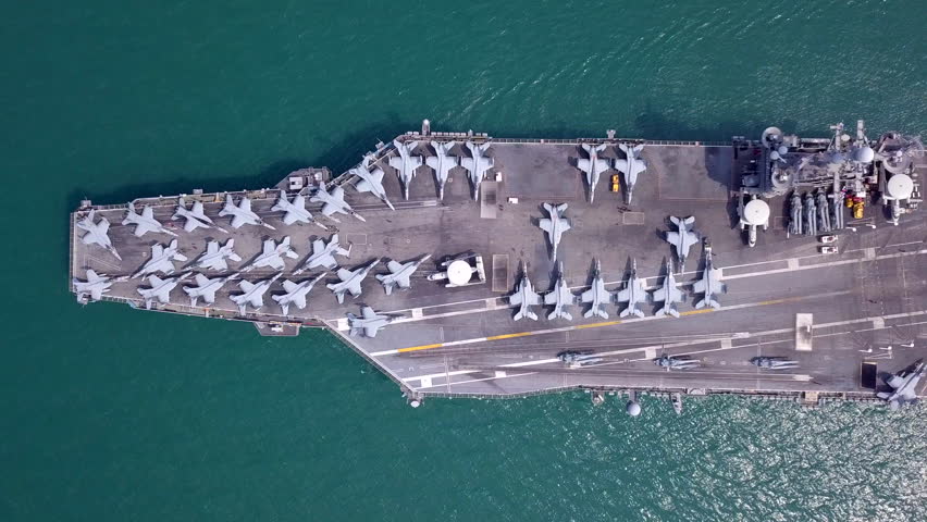 Aircraft carriers, warships, nuclear-powered ships, carrying a large number of aircraft sailing at sea.