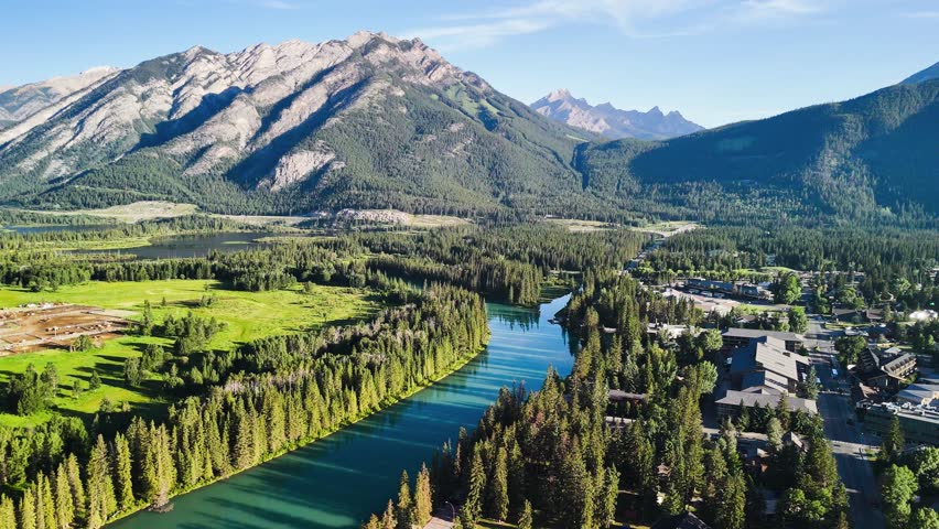Panoramic aerial shot of Banff National Park with lush green valley in summer