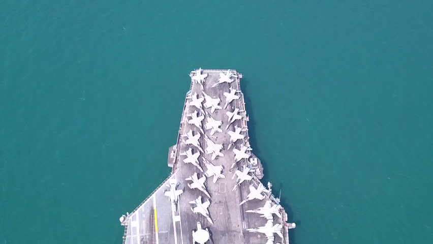 Aircraft carriers, warships, nuclear-powered ships, carrying a large number of aircraft sailing at sea.