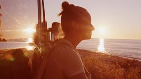 Woman traveler enjoying sunset at sea standing near motorhome on seashore. - Powered by Shutterstock - Get 15% off with code: PIKWIZARD15