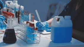 Medical or scientific researcher or man doctor looking at a test tube of clear solution in a laboratory - Powered by Shutterstock - Get 15% off with code: PIKWIZARD15