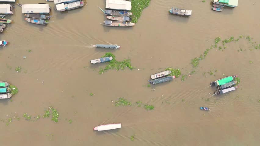 Aerial view of Cai Rang floating market, Can Tho, Vietnam. Tourists, people buy and sell food, vegetable, fruits on boat, ship at river market in Tet Holiday.