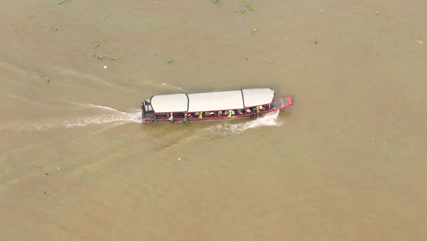 Aerial view of Cai Rang floating market, Can Tho, Vietnam. Tourists, people buy and sell food, vegetable, fruits on boat, ship at river market in Tet Holiday.
