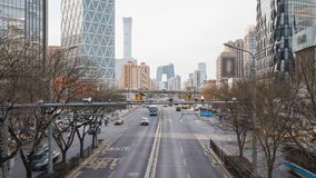 Traffic Time Lapse in the Central Business District (CBD) of Beijing, China, with iconic landmark the CCTV Headquarters building in background. Busy road filled with car commuters during rush hour. - Powered by Shutterstock - Get 15% off with code: PIKWIZARD15