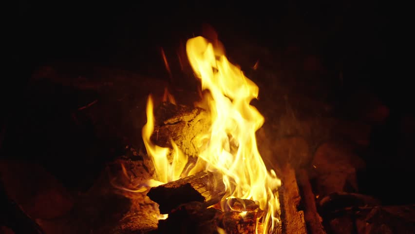 Burning flames. Burning fire for barbecue. Bonfire for BBQ. Campfire fire at night. Cozy campfire in camp. Glowing campfire. Camping lifestyle. Bonfire night. Slow motion. Camping bonfire