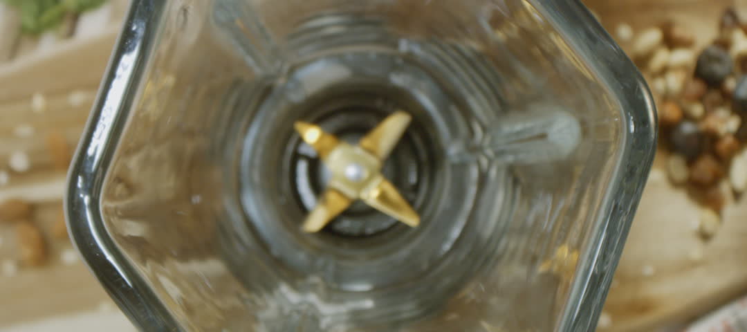 Pouring fresh milk into a blender while preparing smoothie with the addition of fruits and berries. Organic smoothie for a healthy lifestyle