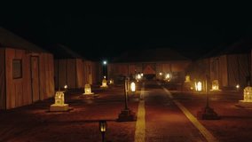 Glamping in the Sahara Desert at night with lanterns and lights illuminating the campsite, offering an enchanting and luxurious camping experience amidst the vast desert landscape. - Powered by Shutterstock - Get 15% off with code: PIKWIZARD15