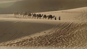 Camel Caravan Trekking Across the Sahara Desert at Sunrise. A captivating scene of a traditional camel caravan traversing the vast expanse of the Sahara Desert. The warm glow of the rising sun casts - Powered by Shutterstock - Get 15% off with code: PIKWIZARD15