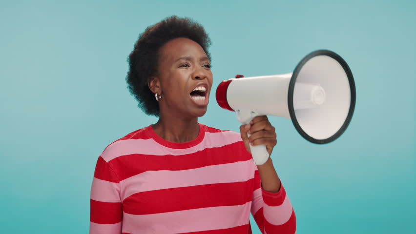 Shout, megaphone and black woman in studio for motivation, protest and announcement. Excited, revolution and person with loud speaker for opinion, attention and gender equality on blue background