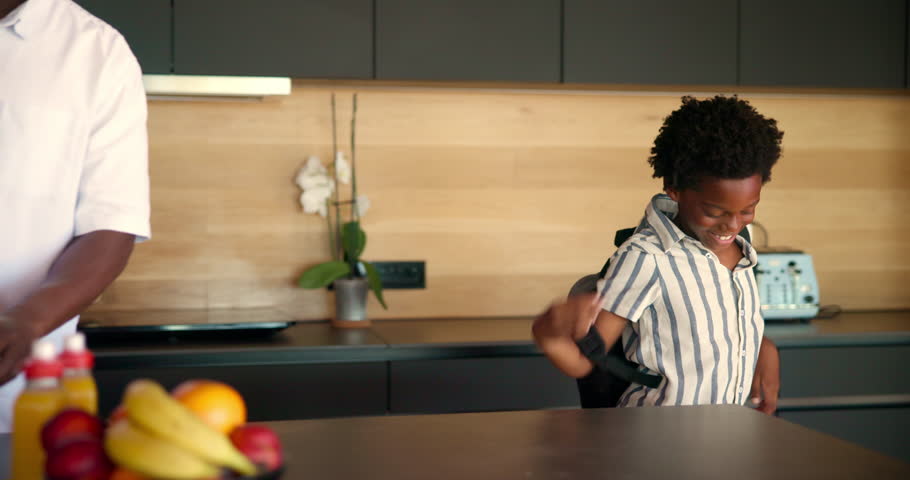 Home, father and high five child with backpack for education support, back to school and getting ready to leave. Black family, man and greeting kid in kitchen for bonding, relationship and love