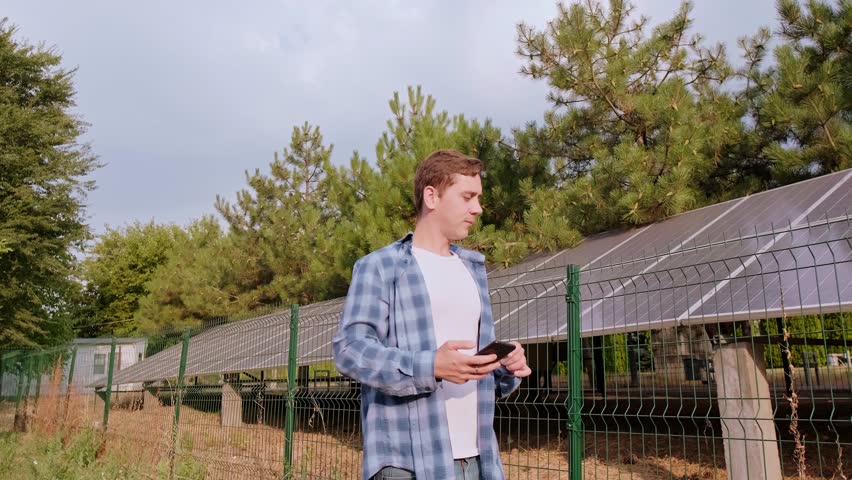 Data analyst and energy consultant standing with his back, analyzing solar system efficiency, evaluating performance, and suggesting improvements.