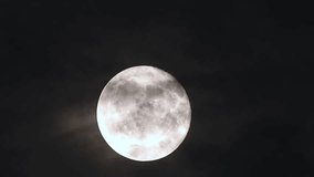 Dramatic full moon rise through drifting dark clouds in 4k cinematic time lapse - Powered by Shutterstock - Get 15% off with code: PIKWIZARD15
