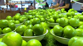 Fresh limes displayed at a bustling market - Powered by Shutterstock - Get 15% off with code: PIKWIZARD15