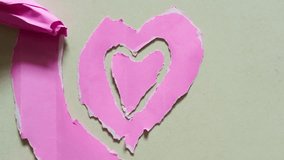 Stop motion of heart shape made out of torn pink paper - Powered by Shutterstock - Get 15% off with code: PIKWIZARD15