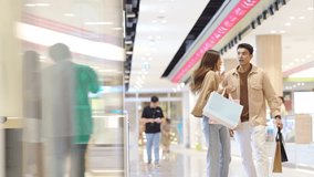 Happy Asian family man and woman shopping, buying goods at department store. Couple enjoy urban lifestyle holding shopping bag walking and looking at store in shopping mall on summer holiday vacation. - Powered by Shutterstock - Get 15% off with code: PIKWIZARD15