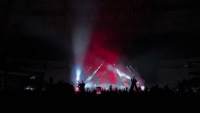 Lively concert with hands raised, illuminated by bright stage lights.  - Powered by Shutterstock - Get 15% off with code: PIKWIZARD15