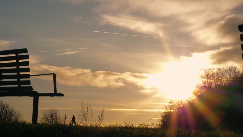 Bench overlooking view at sunset medium shot selective focus