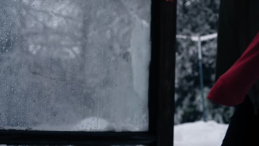 Woman comes into house on winter day after snow medium 4k shot selective focus
