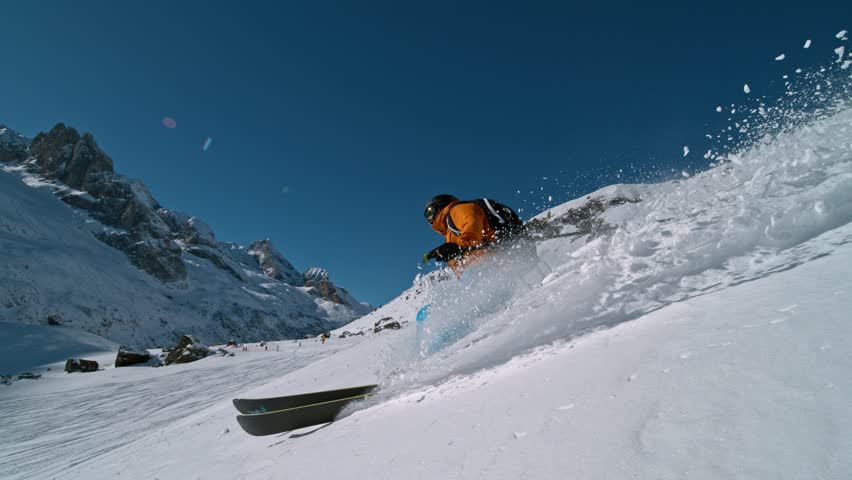 Skier riding in the scenic Dolomites mountains in fresh powder snow. Super slow motion at 1000 fps.
