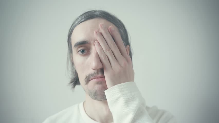 face palm Odd weird Slavic Man Staring Scenic Young Slavic man with a mustache and long hair gazes oddly into the camera against a picturesque background
