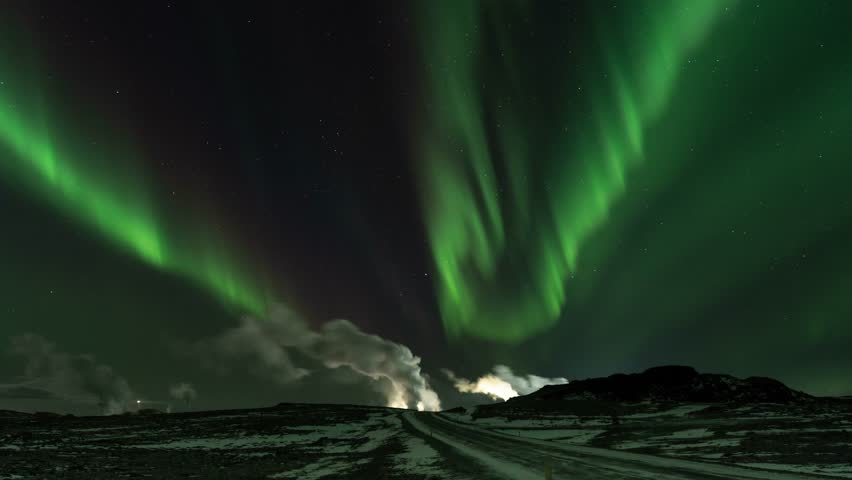 Stable timelapse at 25 frames per second shows dancing aurora above a geothermal powerplant.
