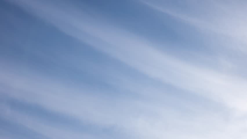 White clouds moving fast from right to left time-lapse. Daylight cloudy heaven background. Long timelapse light clouds transforming in blue sky with motion blur. Perfect for text, titles, logo