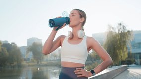 Athletic fit sport runner girl drinking water from bottle after training exercise. Workout cardio in park in morning. Young slim woman jogger enjoy healthy lifestyle. Active sportswoman activities. - Powered by Shutterstock - Get 15% off with code: PIKWIZARD15