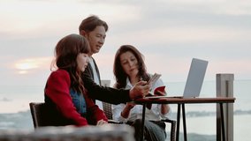 Happy creative colleagues having fun while talking, relaxing, looking at a smartphone together on the roof top of hotel at sunset enjoying beach vacation or during a business trip. - Powered by Shutterstock - Get 15% off with code: PIKWIZARD15