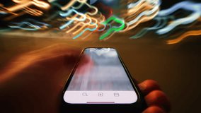 Close-up time-lapse hyperlapse of male hand scrolling social networks on smartphone screen walking city street at night, fast motion light trails, pov cellphone scrolling apps surf internet web pages - Powered by Shutterstock - Get 15% off with code: PIKWIZARD15