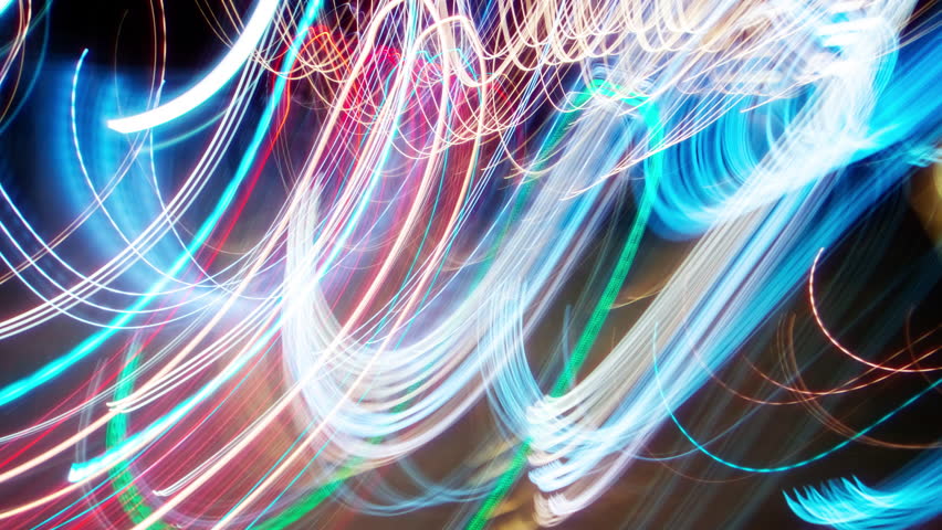 Timelapse flickering light trails. Blurry colorful city streak lights glowing at night, long exposure transformations bright multicolored street illumination. Curved lines change with strobe effect