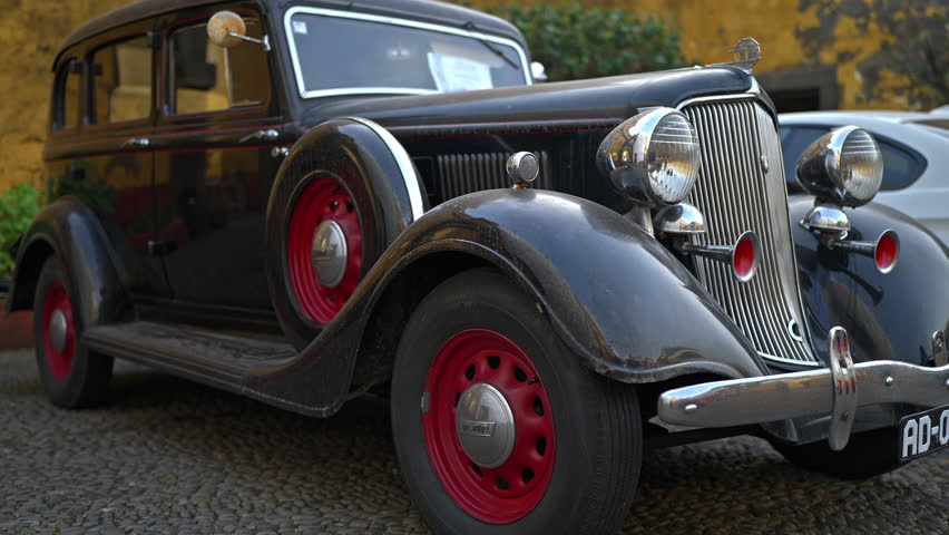 restored retro car parked on street, black vintage automobile, Plymouth brand auto, collectible American classic vehicle