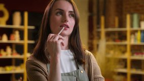 Art designer craftswoman at creative ceramics workshop thoughtful thinking woman pottery sculptor artist think ponder planning small business owner girl handmade class ideas painting craft industry - Powered by Shutterstock - Get 15% off with code: PIKWIZARD15