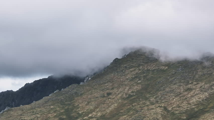 Clouds enveloping a mountain peak