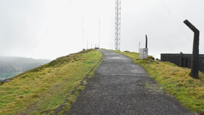 Road leading up to scenic view point of the Lagoa do fogo, crater lake on the Azores island, Portugal, misty view point, hiking routes.