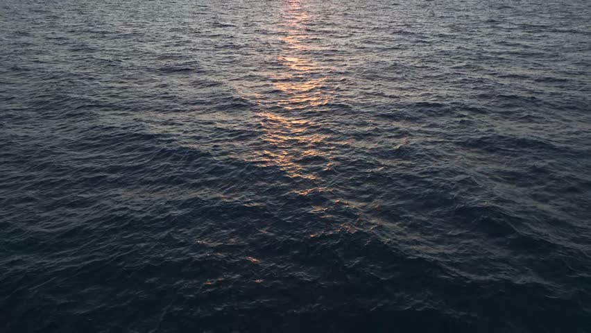 Aerial Video Sunset Reflecting on the Ocean s Surface with Dynamic Water Textures and Waves