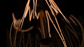 Macro shot of Edison bulb. The filament in the Edison lamp becomes hot and glows brightly from the voltage. Super macro video. Electricity in the modern world. - Powered by Shutterstock - Get 15% off with code: PIKWIZARD15