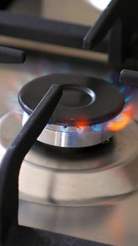 Gas oven with flame at the kitchen