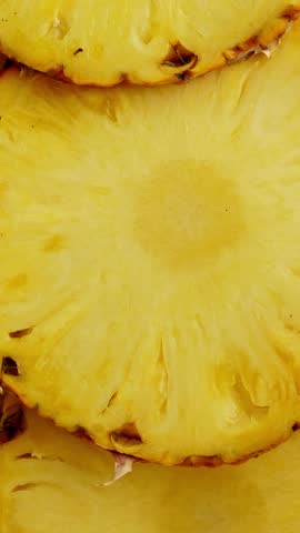 Sliced pieces of pineapple fruit. rotating food