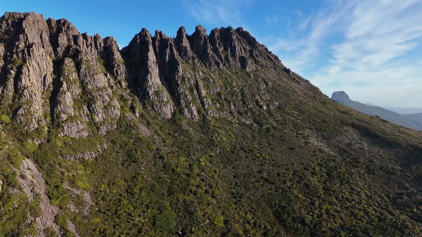 Cradle Mountain Peak in World Heritage Area. Tasmania in Australia. Aerial drone footage flying backwards