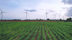 Aerial drone shot flying outdoors above the wind turbine field view. Landscape of the windmill power turbines farm generating clean renewable energy for sustainable development in rural area at sunset - Powered by Shutterstock - Get 15% off with code: PIKWIZARD15