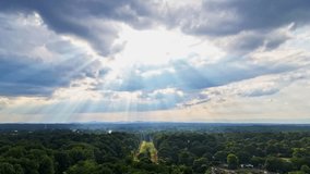 Beautiful and perfect cinematic drone shot showing rays of sun streaking through storm clouds in Greenville, SC. Shining on the Duke Power lines...hope after Hurricane Helene for power... - Powered by Shutterstock - Get 15% off with code: PIKWIZARD15