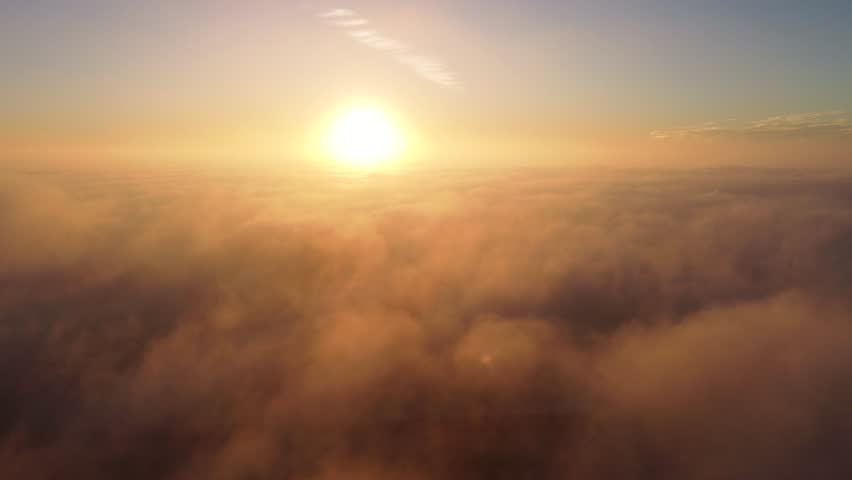 Reveal Newport Beach - Santa Ana Skyline, Above the Clouds and Smokey Sea Fog at Sunset. Orange County Coast, Southern California, USA. Coastal City, Downtown Skyline. California Wildfire Season.