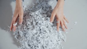 Top down view of Shredded paper office documents in worker woman hands. Close up - Powered by Shutterstock - Get 15% off with code: PIKWIZARD15