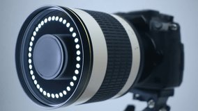 A professional camera on a tripod with a powerful mirror zoom lens that reflects the ring LED light. Closeup. Macro - Powered by Shutterstock - Get 15% off with code: PIKWIZARD15
