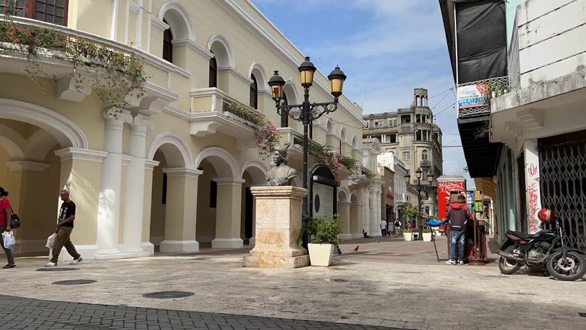 Santo Domingo , Distrito Nacional , Dominican Republic - 08 05 2024: Time Lapse of pedestrians walking along the popular shopping street Calle El Conde next to Parque Colón in the historic Zona Coloni