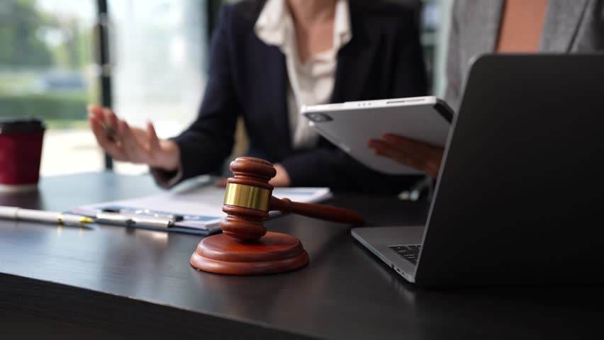 Teamwork of business lawyer meeting working hard about legal legislation in courtroom to help their customer.