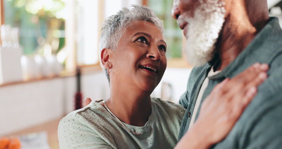 Elderly, couple and hug for comfort at house of love, marriage commitment and retirement support. Interracial, people and embrace for relationship romance, bonding together and care of partner safety