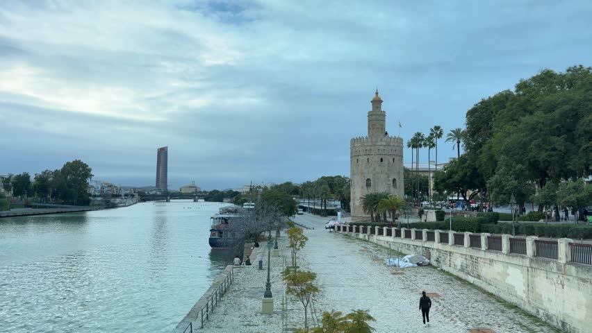 Panoramic view of the river with the Torre del Oro in Seville, historical and cityscape