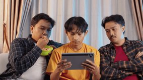 Disappointment friends reacting while watching match on tablet. Sad and disappointed expressive emotions in cozy living room. Goal celebration, sports streaming, watching tablet - Powered by Shutterstock - Get 15% off with code: PIKWIZARD15